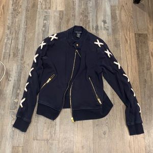 Women’s navy and white jacket with gold zipper and button at top